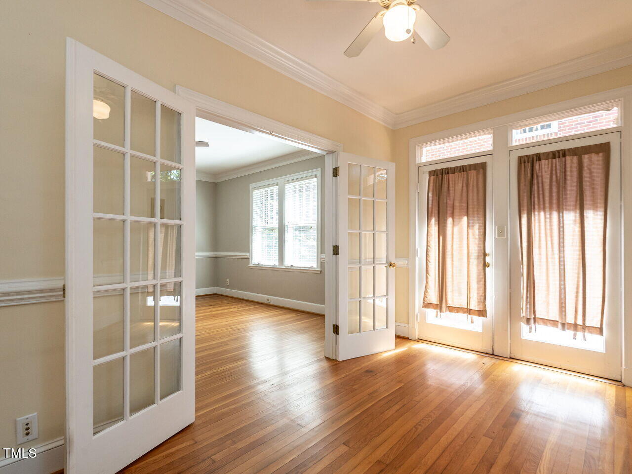 2715 Vanderbilt Avenue Raleigh, NC 27607 - Photo 11 of 36 a view of an empty room with wooden floor and a window