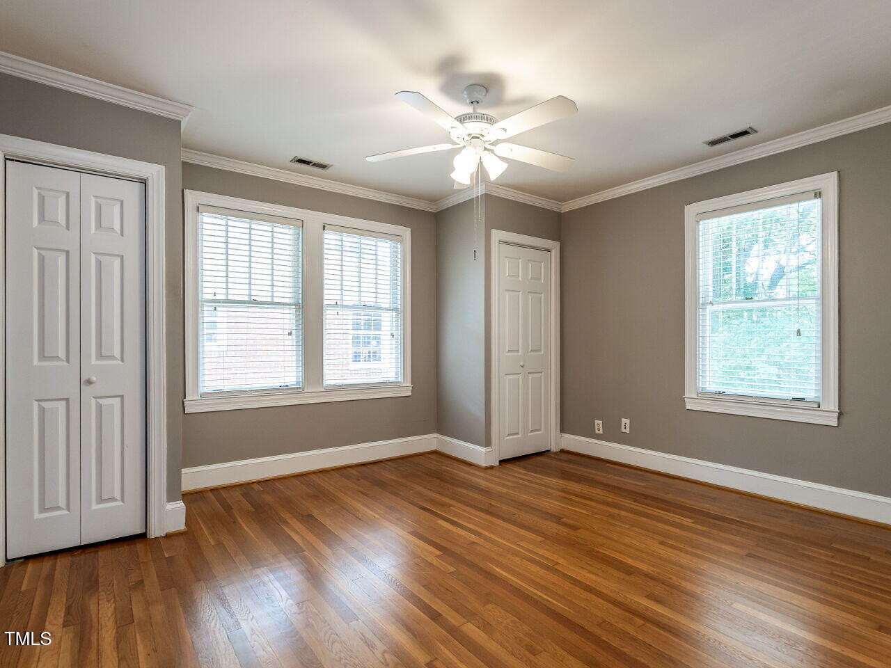 2715 Vanderbilt Avenue Raleigh, NC 27607 - Photo 19 of 36 a view of an empty room with wooden floor and a window