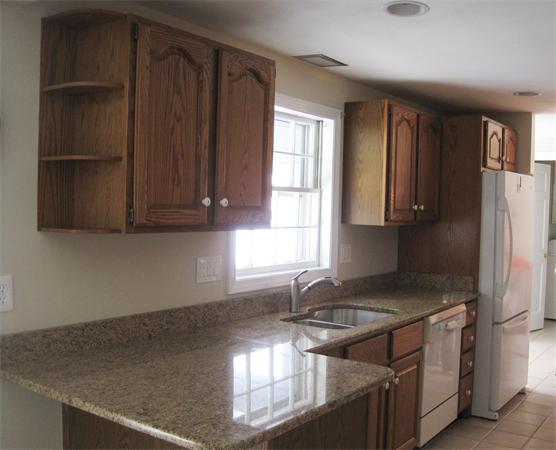 23 Porter Road Chelmsford, MA 01824 - Photo 5 of 21 a kitchen with stainless steel appliances granite countertop a sink stove and refrigerator