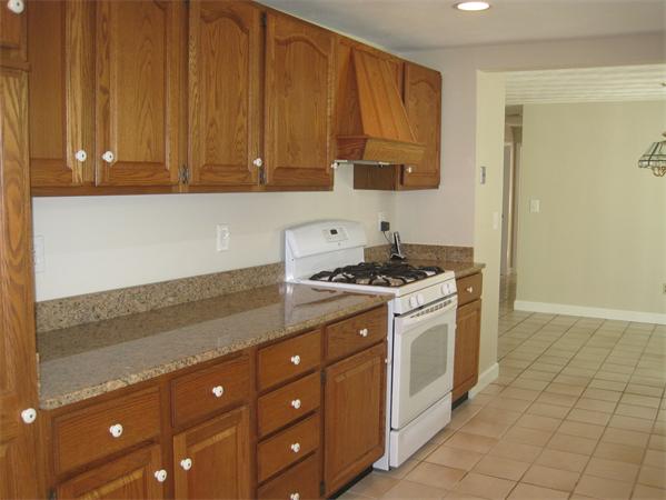 23 Porter Road Chelmsford, MA 01824 - Photo 6 of 21 a kitchen with stainless steel appliances granite countertop a sink a stove and a microwave