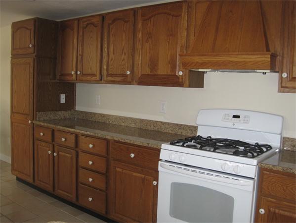 23 Porter Road Chelmsford, MA 01824 - Photo 7 of 21 a kitchen with granite countertop cabinets and a stove top oven
