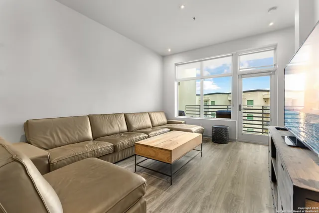 a living room with furniture and a large window