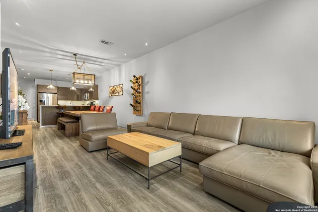 a living room with furniture and wooden floor