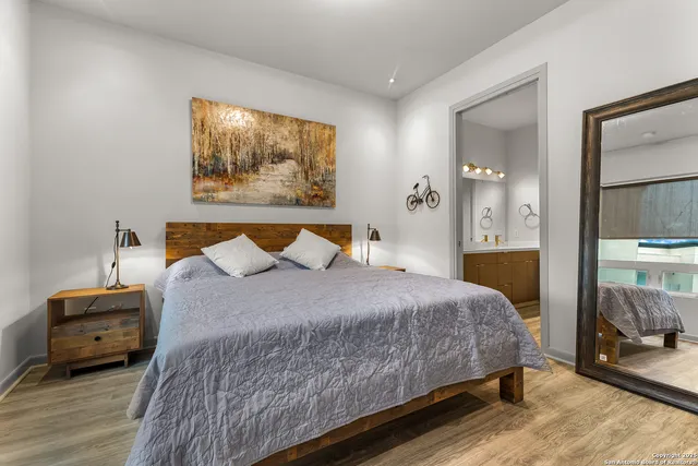 a bedroom with a bed and wooden floor