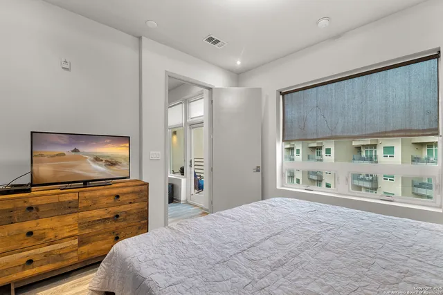a bedroom with furniture and flat screen tv