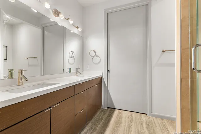 a bathroom with a double vanity sink mirror and