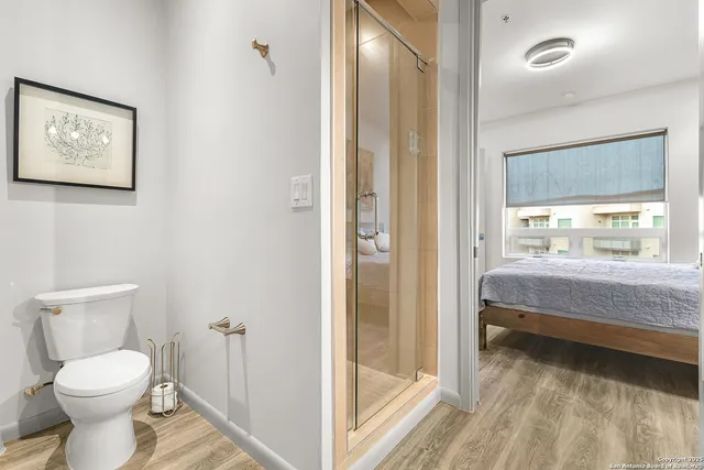 a bathroom with a toilet and a shower