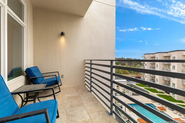 a view of a chairs and table in a balcony