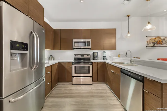 a kitchen with stainless steel appliances and a refrigerator