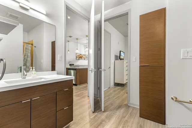 a bathroom with a granite countertop sink shower and a mirror