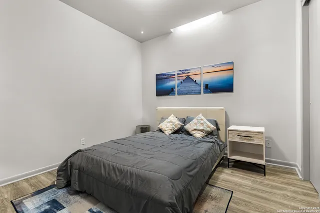 a bedroom with a bed and a night stand