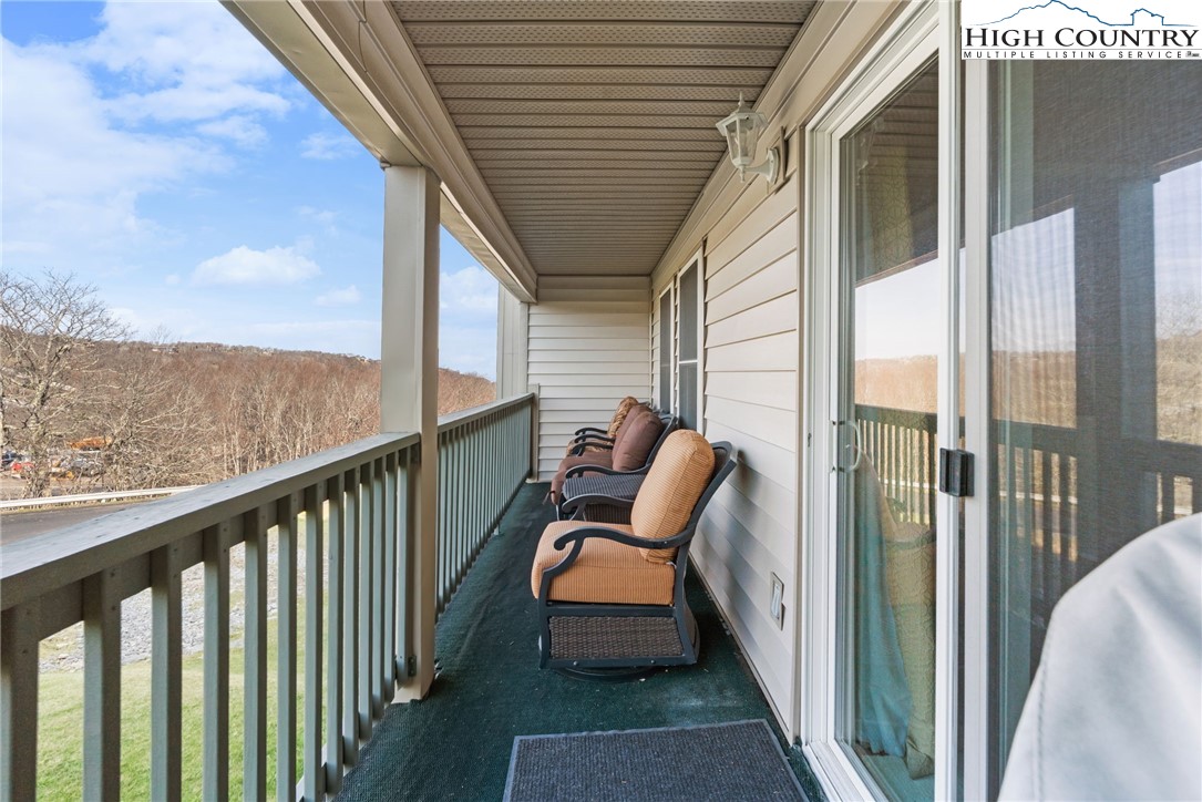301 Pinnacle Inn Road, Unit 3219 Beech Mountain, NC 28604 - Photo 20 of 30 a balcony with wooden floor stairs and outdoor seating