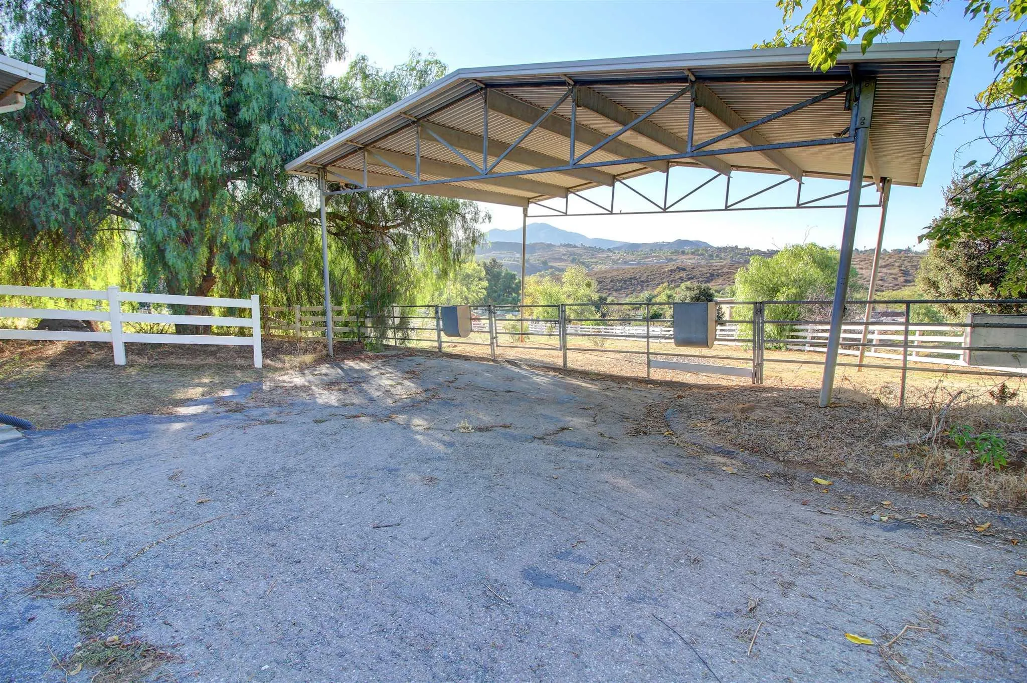 15245 Presilla Drive Jamul, CA 91935 - Photo 50 of 57 a view of a backyard with table and chairs under an umbrella