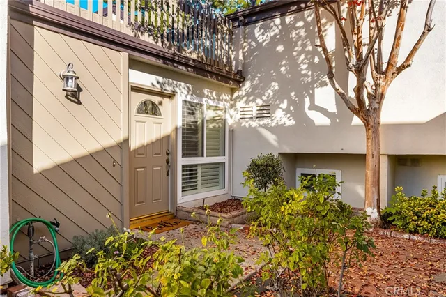 a backyard of a house with flower plants