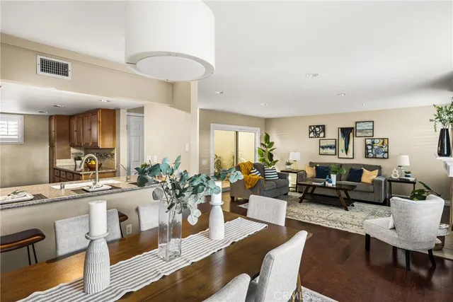 a living room with furniture kitchen and a table