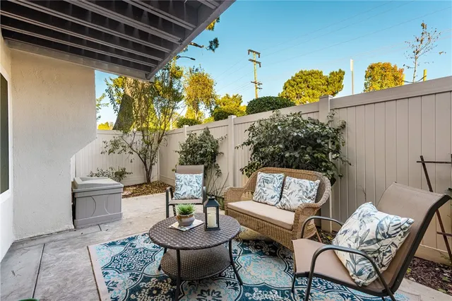 a outdoor living room with furniture and a potted plant