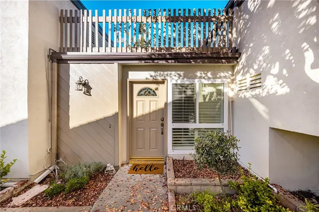a front view of a house with a tree