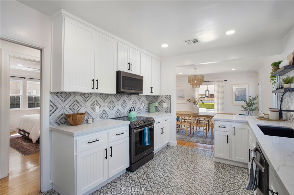 134 Prospect Avenue Long Beach, CA 90803 - Photo 12 of 21 a kitchen with stainless steel appliances granite countertop a sink and cabinets