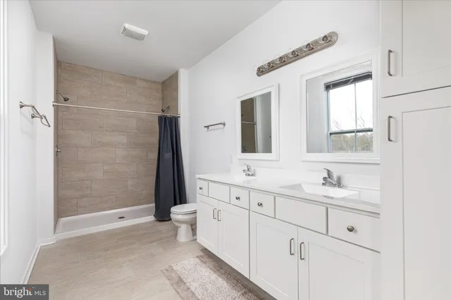 a bathroom with 2 sink tub and a mirror