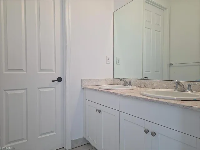 a bathroom with a sink and vanity