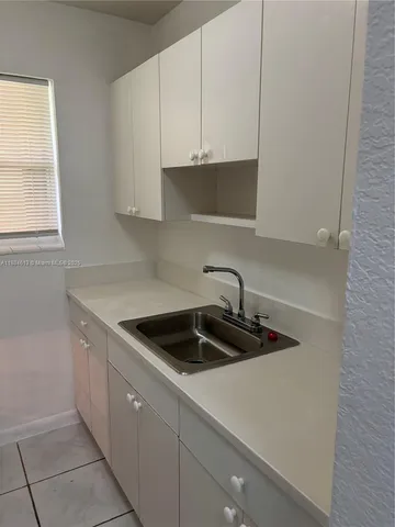 a kitchen with a sink and cabinets