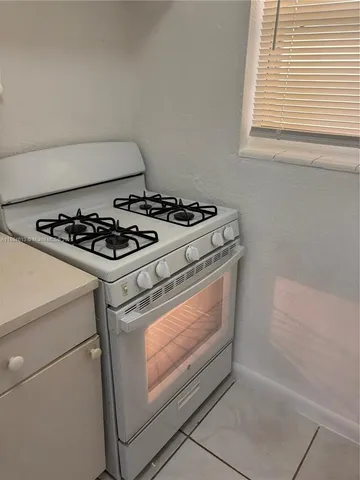 a stove top oven sitting inside of a kitchen