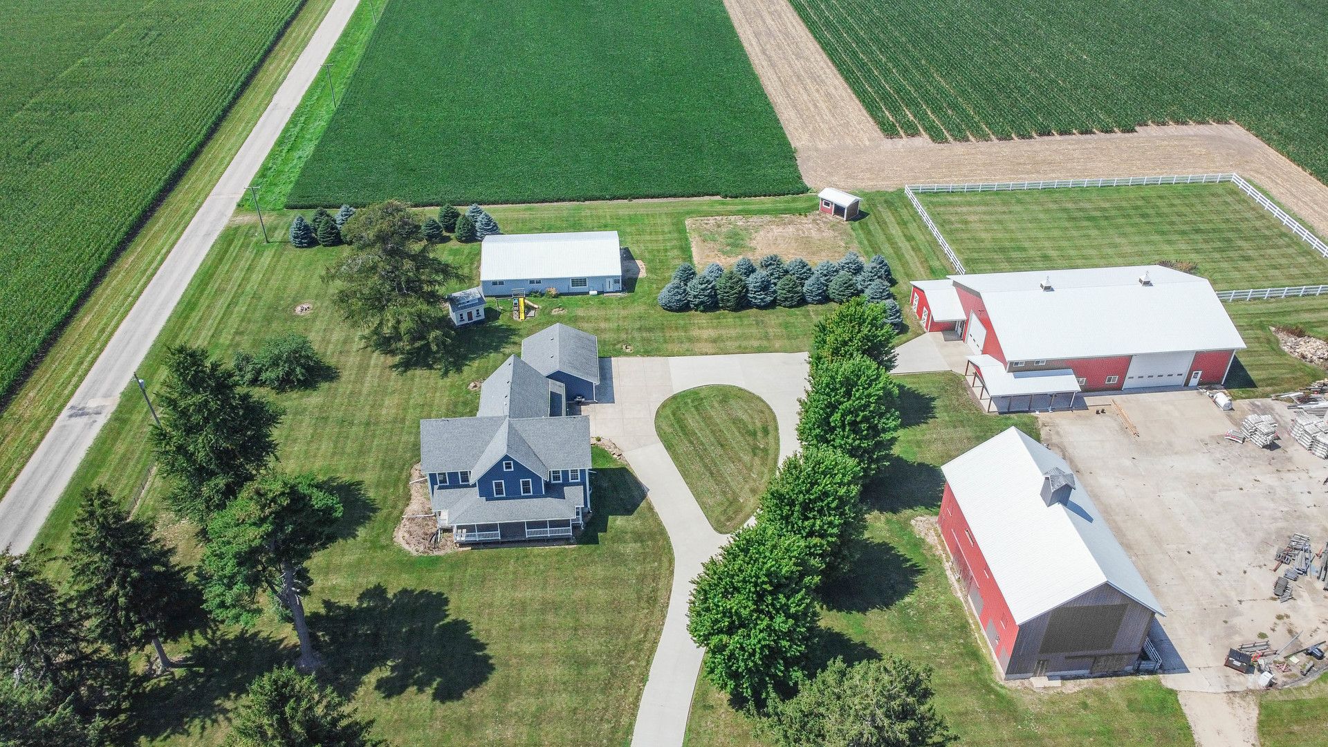 an aerial view of a house with a yard and lake view