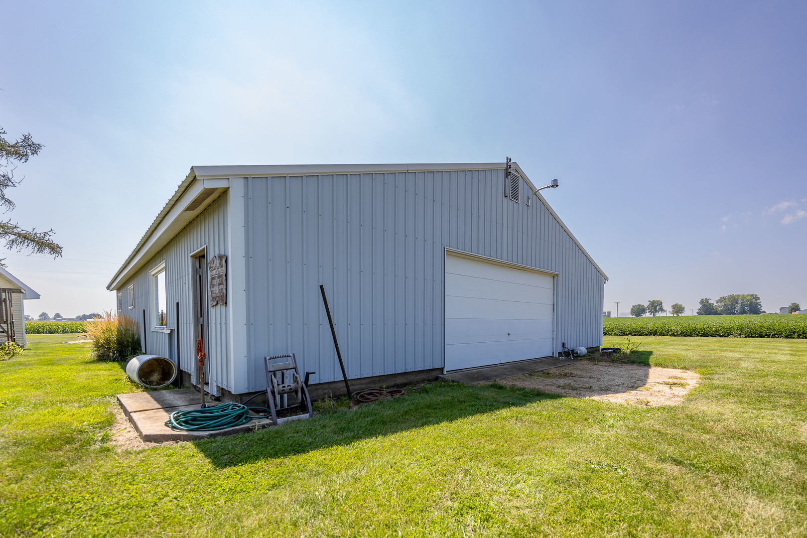 1353 Pine Hill Road Amboy, IL 61310 - Photo 74 of 91 a backyard of a house with wooden fence and a bench