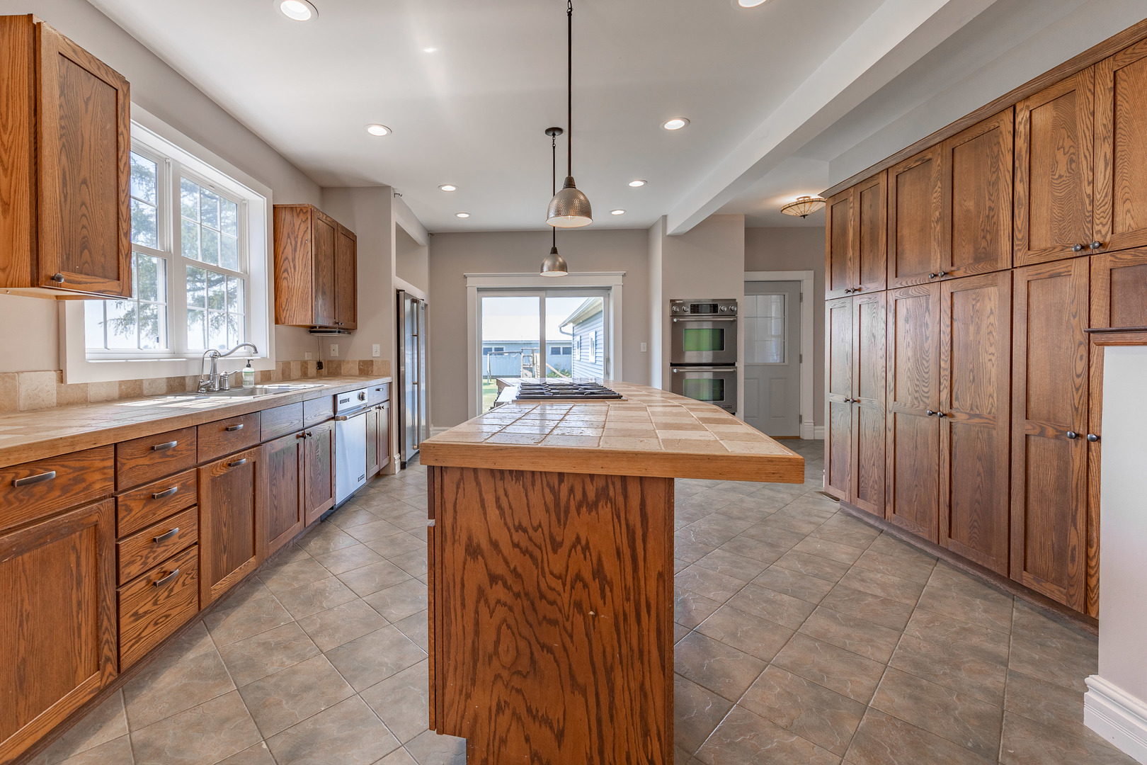 1353 Pine Hill Road Amboy, IL 61310 - Photo 8 of 91 a large kitchen with kitchen island granite countertop a sink refrigerator and cabinets