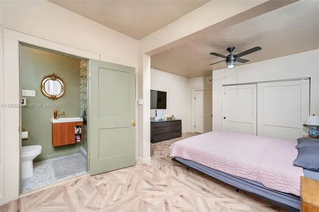 a bedroom with a bed and a chandelier