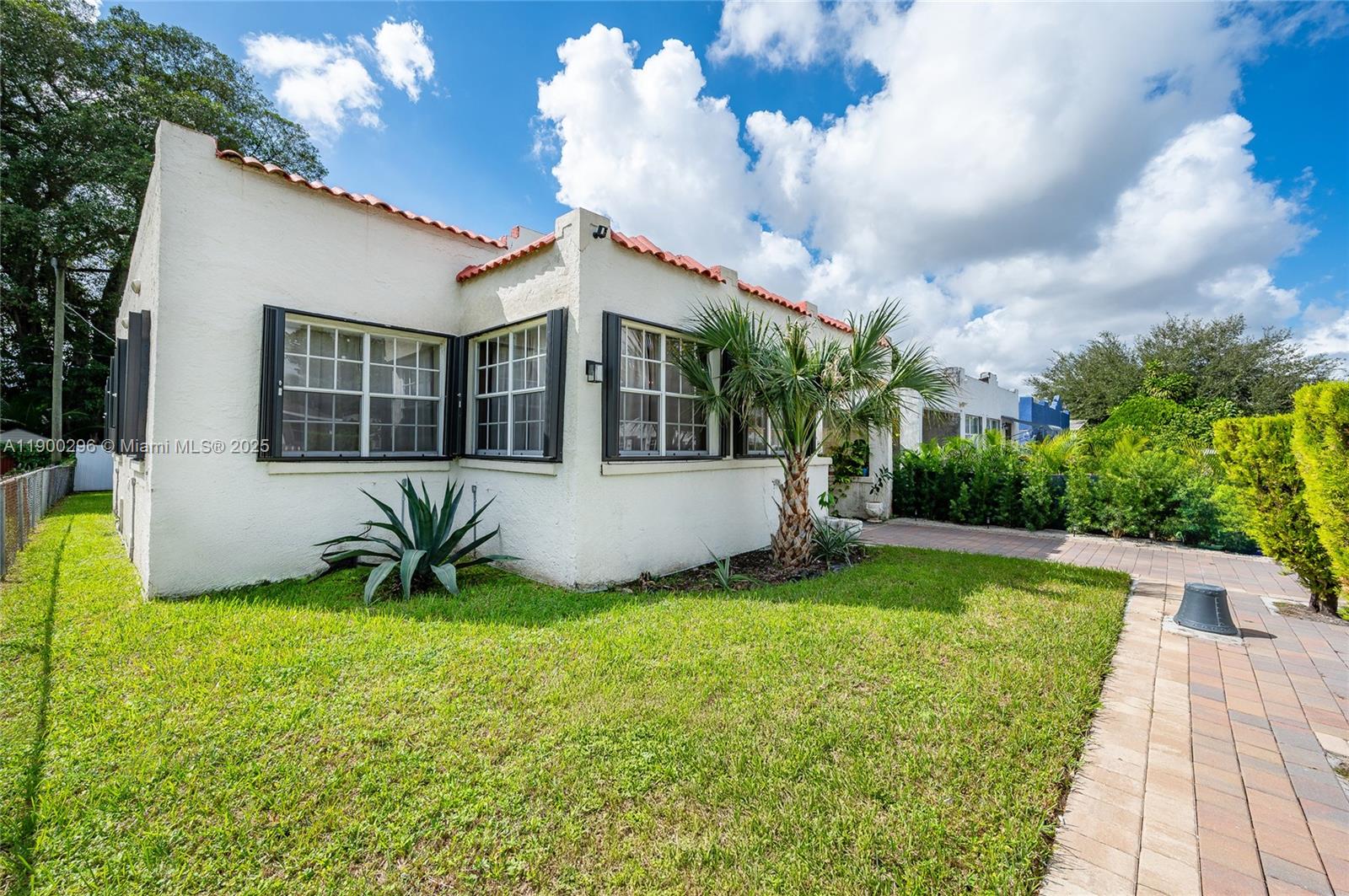 1844 Northwest 47th Street Miami, FL 33142 - Photo 3 of 24 a view of a house with a yard