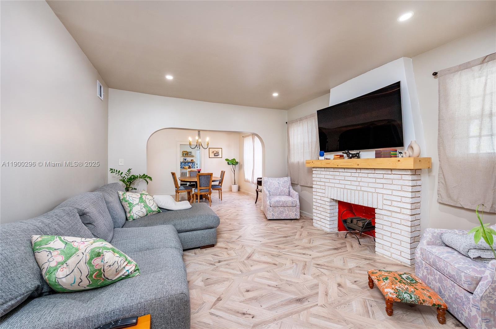 1844 Northwest 47th Street Miami, FL 33142 - Photo 4 of 24 a living room with furniture and a flat screen tv