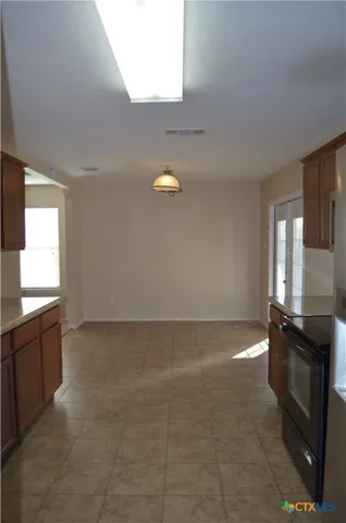 a view of a small space with wooden floor and a window