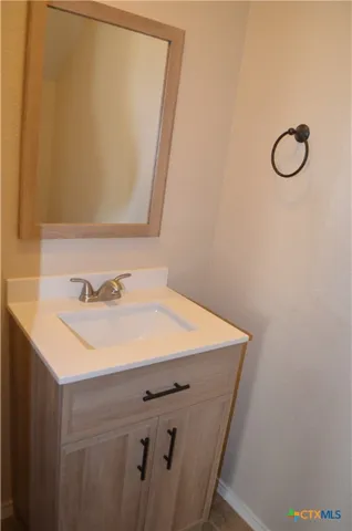 a bathroom with a sink double vanity and a mirror