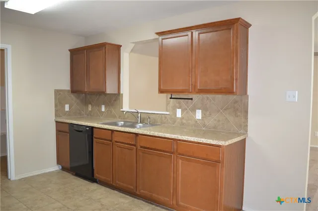 a kitchen with stainless steel appliances granite countertop a sink and cabinets