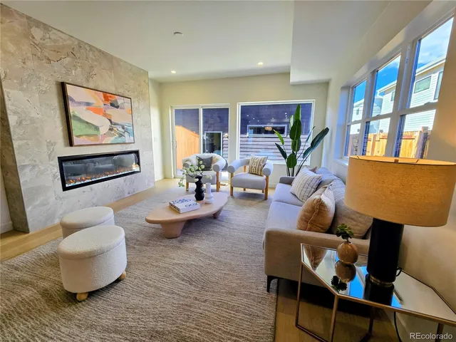 a living room with furniture and a painting on the wall