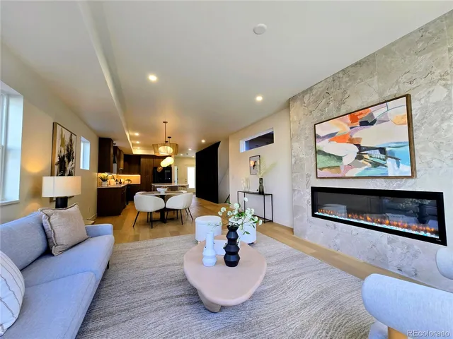 a living room with furniture kitchen view and a flat screen tv