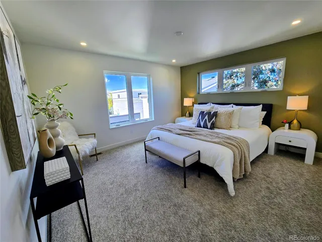 a spacious bedroom with a bed and a chandelier