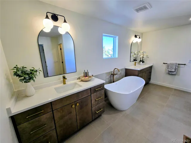 a bathroom with a sink double vanity and a mirror
