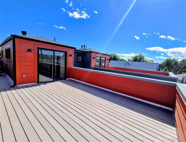 a view of a room with wooden floor and potted plants