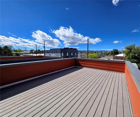 a view of a balcony with wooden floor