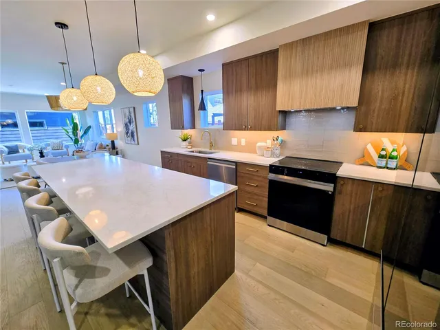 a kitchen with a stove a kitchen island wooden cabinets and a counter top space