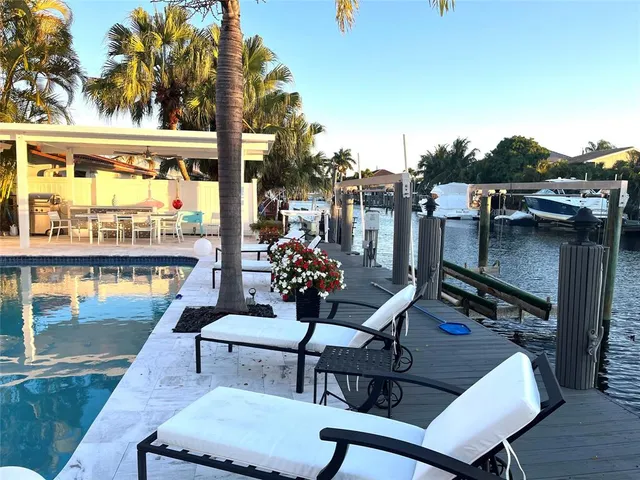 a view of a house with backyard and sitting area