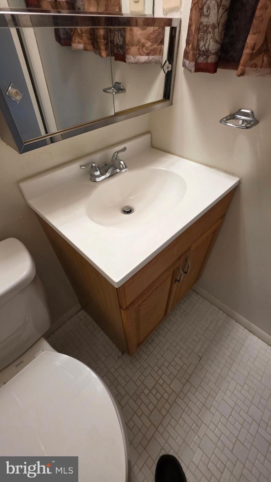 3928 Rolling Rd., Unit C10 Pikesville, MD 21208 - Photo 11 of 26 a bathroom with a sink and a mirror