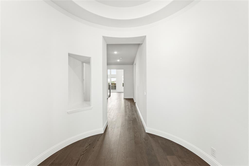 1145 Hitching Post Way Oak Point, TX 75068 - Photo 8 of 39 a view of a hallway with wooden floor