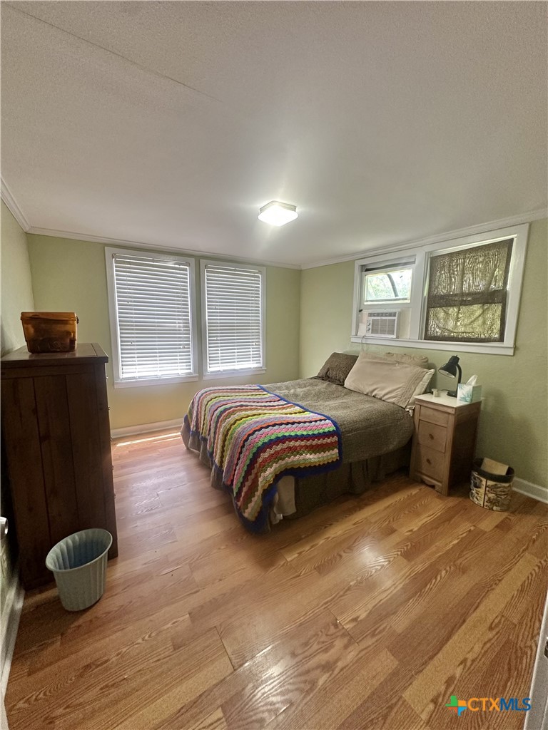 2006 Meadowlane Street Victoria, TX 77901 - Photo 11 of 15 a bedroom with a bed and dresser with wooden floor
