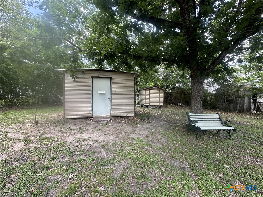 2006 Meadowlane Street Victoria, TX 77901 - Photo 13 of 15 a view of a backyard with a large tree