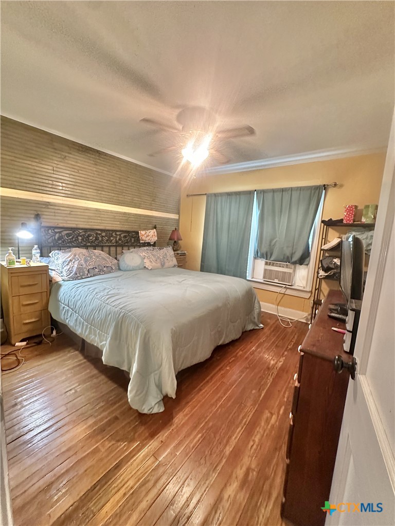 2006 Meadowlane Street Victoria, TX 77901 - Photo 7 of 15 a bedroom with a bed and wooden floor
