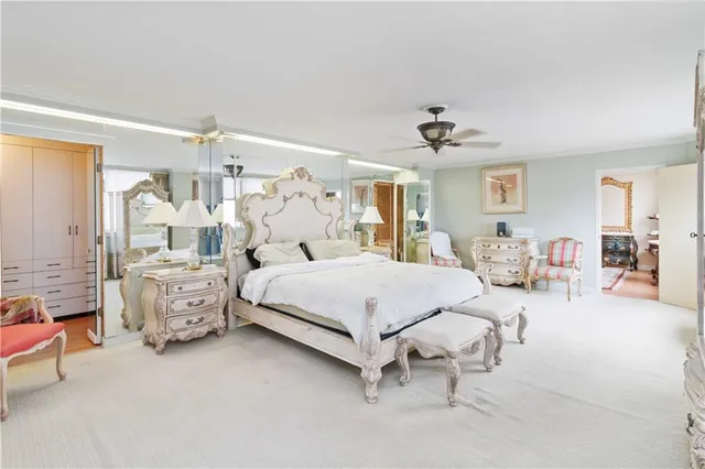 a spacious bedroom with a bed and a chandelier