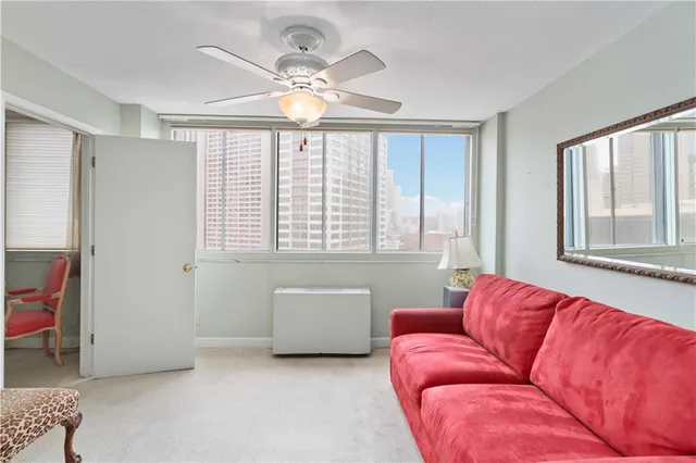 a living room with furniture and a large window